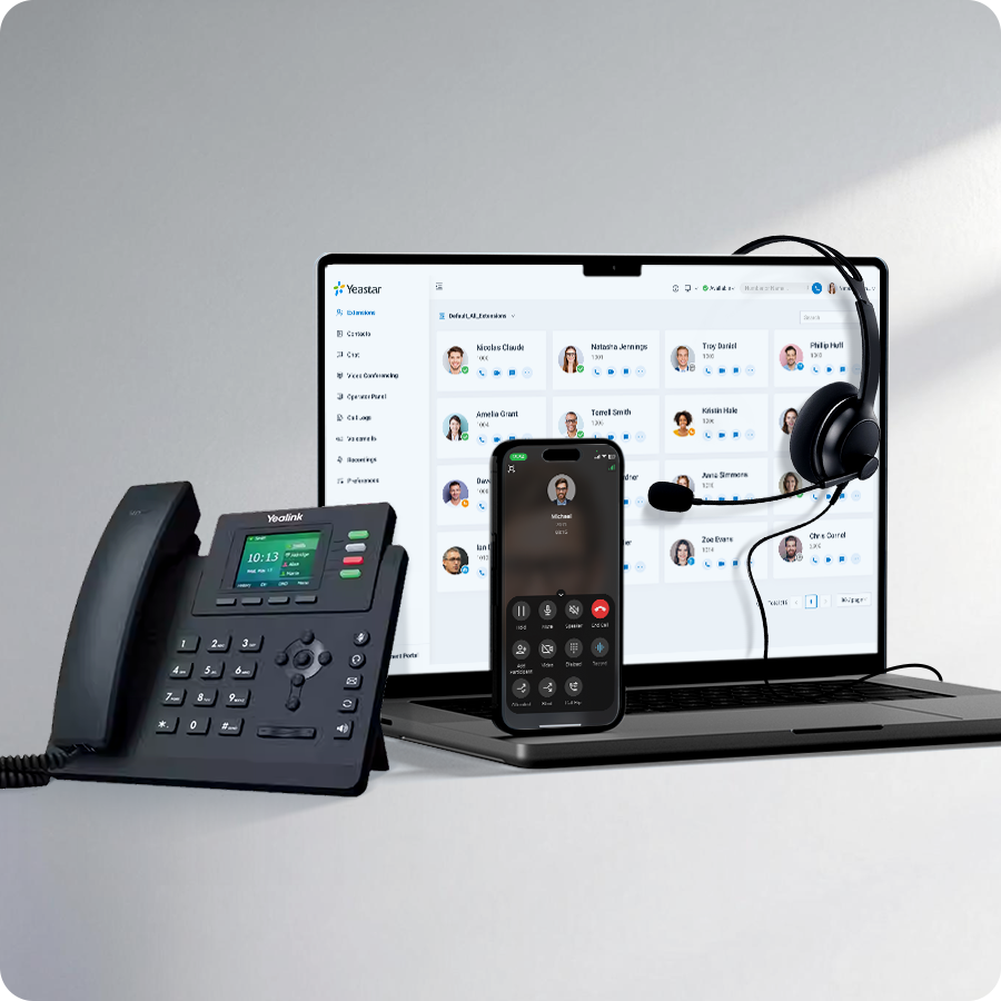 Unified communications setup on a desk: office phone, laptop showing a contact list, wireless headset, and a smartphone during a call/meeting.